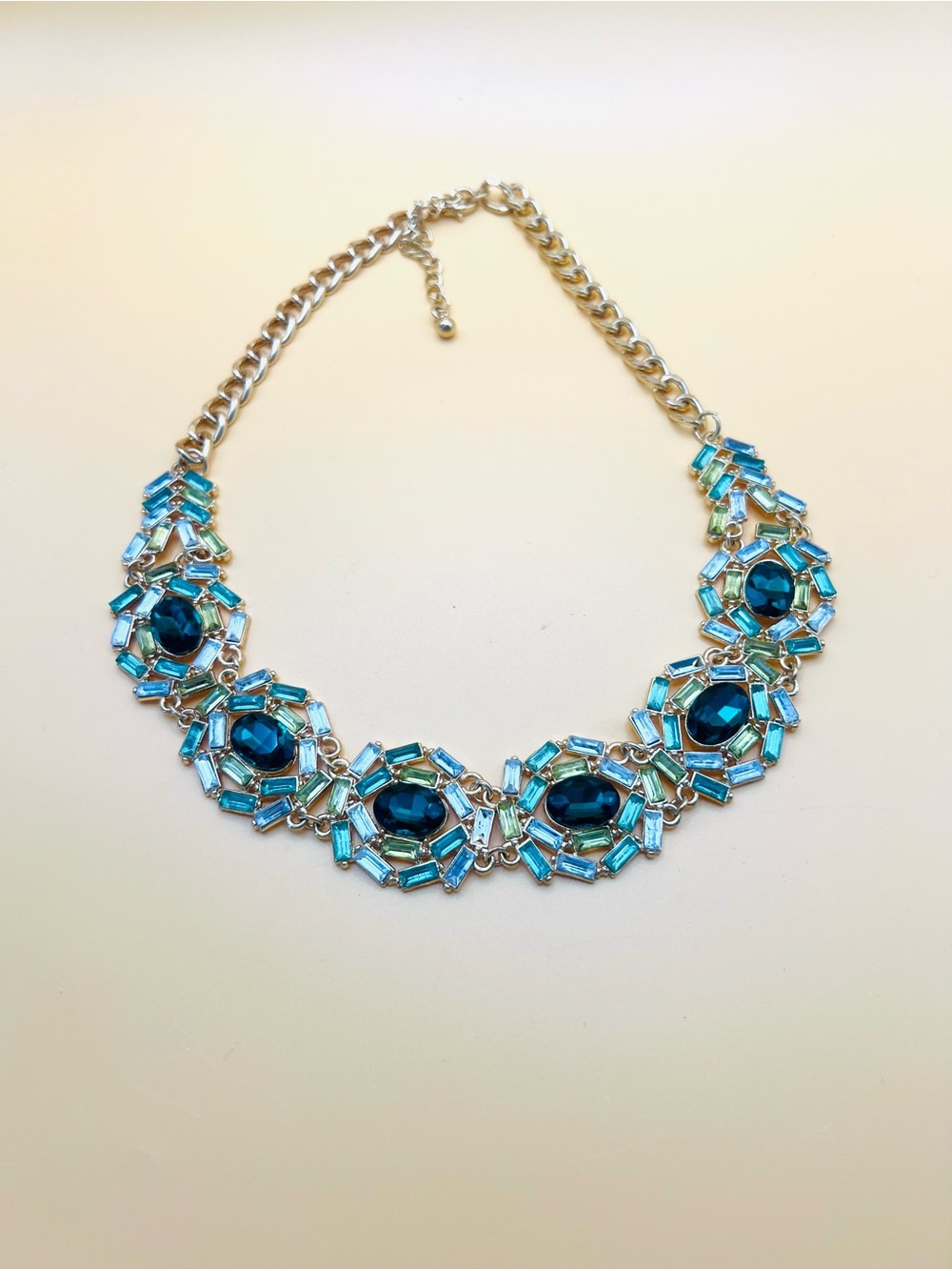 Dark green synthetic emeralds and rhinestones on gold tone chain